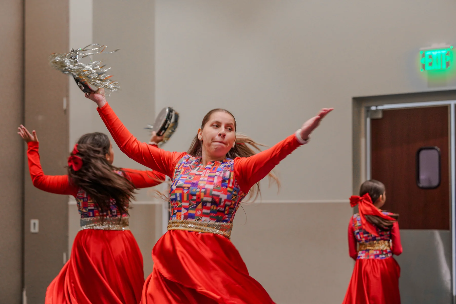 Dancers in red costumes performing at a community event