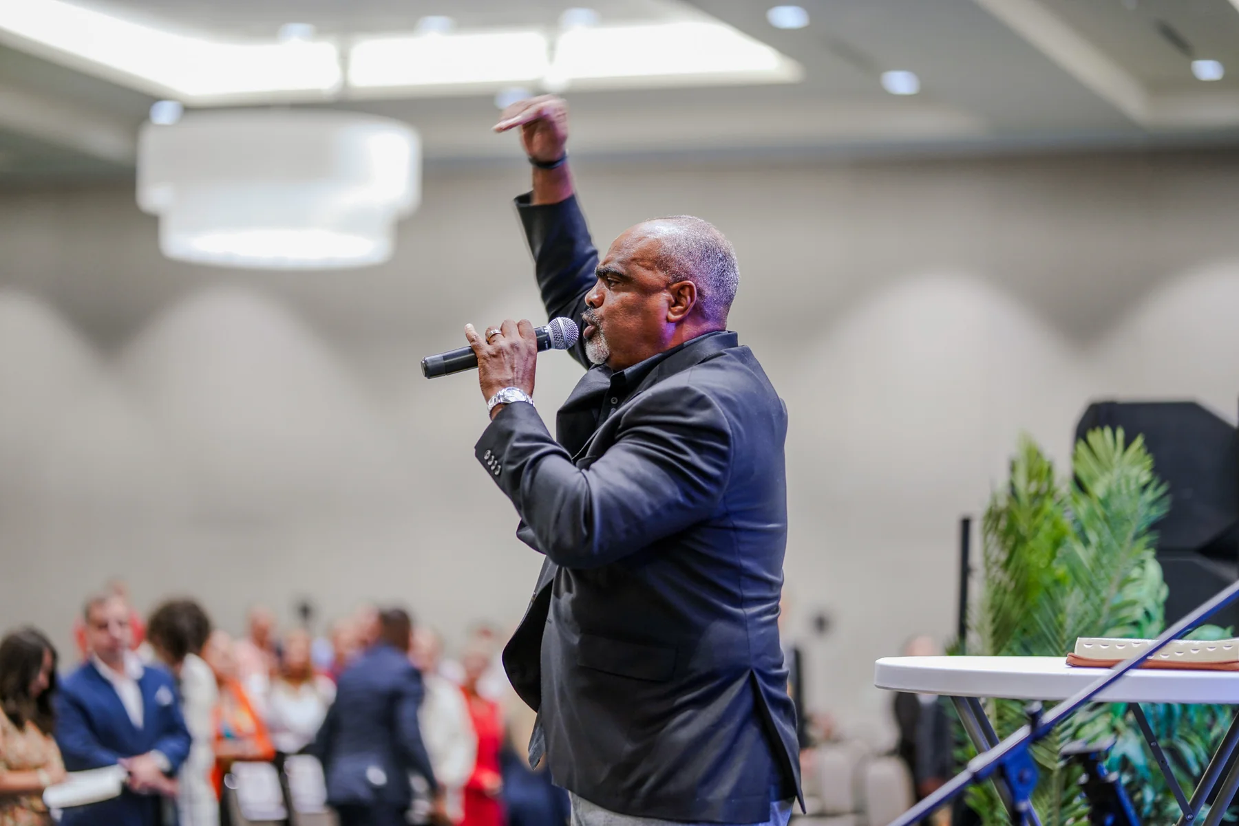 Speaker on stage with a microphone during a live event